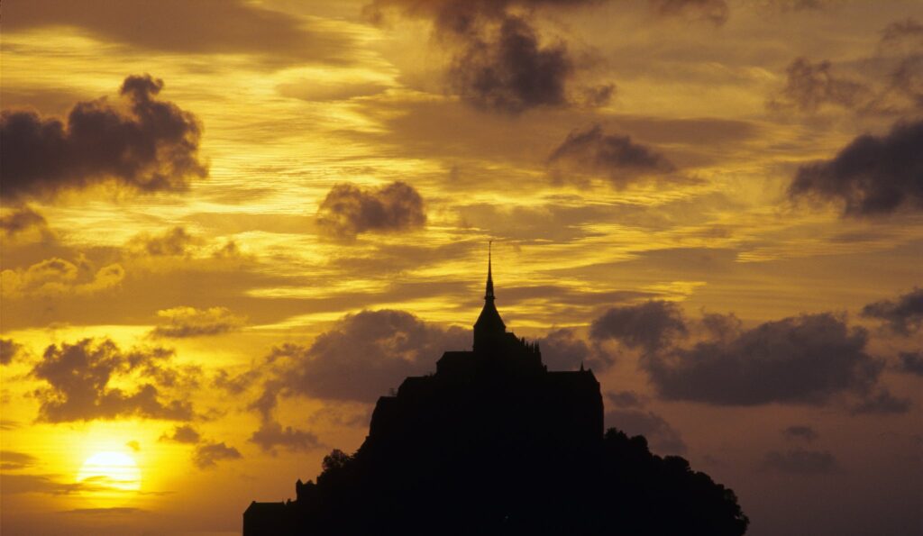 Silhouette of Building under Orange Sky