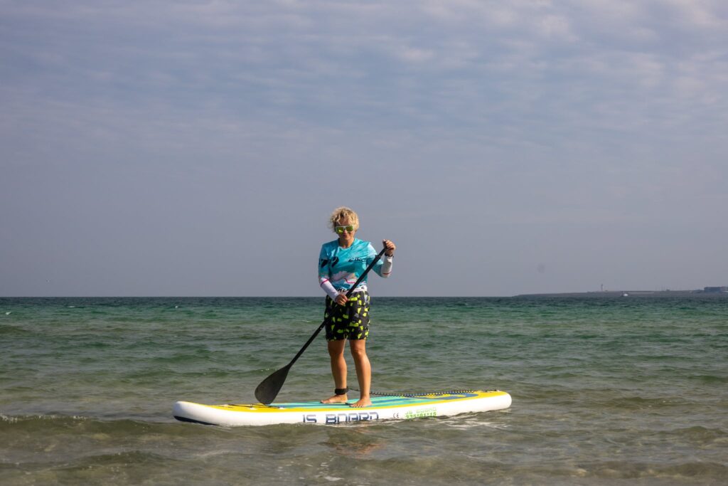 A Woman using a Paddleboard