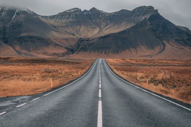 Empty Highway Overlooking Mountain Under Dark Skies